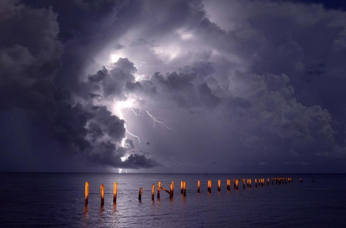 Streaks of lightning illuminate the morning sky in Gulfport. Photographer’s comment: I enjoy going out before the sun rises to get pictures while most people are still sleeping. On this night, I saw the lightning flashes through my bedroom window. I got up and got a location near the overpass at the Veterans Home. Street lights gave a yellow cast and I popped a little flash to even out the light in the foreground. I under exposed the background so the lightning would not over power the photo. This was a 20 second exposure at f22. Of the 25 photos I shot, only four had decent streaks of lightning. Of course, you only need one.