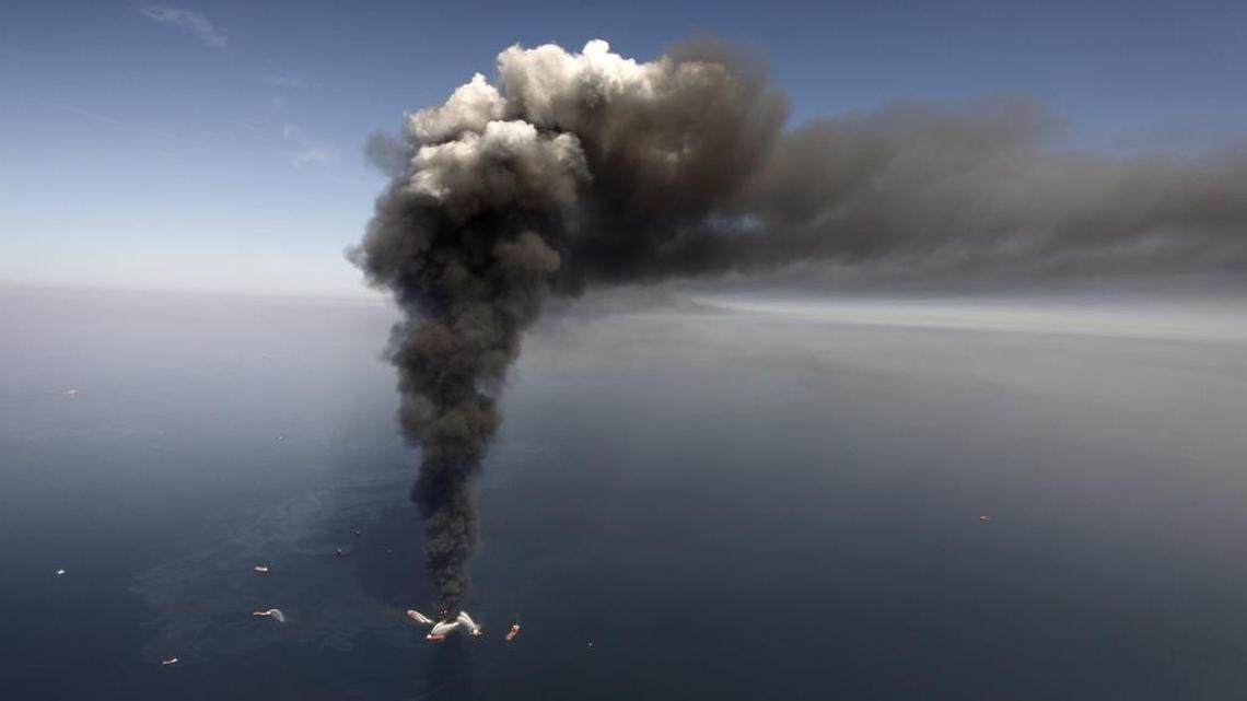 Oil can be seen in the Gulf of Mexico, more than 50 miles southeast of Venice on Louisiana’s tip, as a large plume of smoke rises from fires on BP’s Deepwater Horizon offshore oil rig in April 2010.