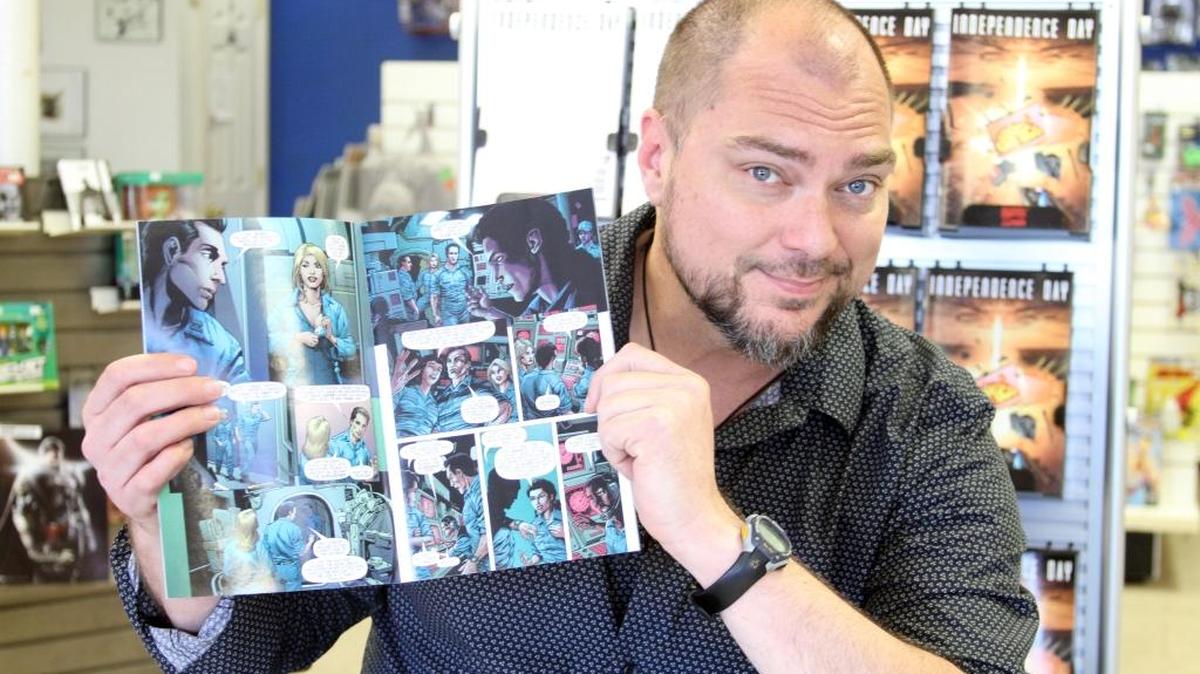 Comic illustrator Steve Scott shows off his comic ‘Independance Day’ at 3 Alarm Comics in St. Martin on Wednesday.