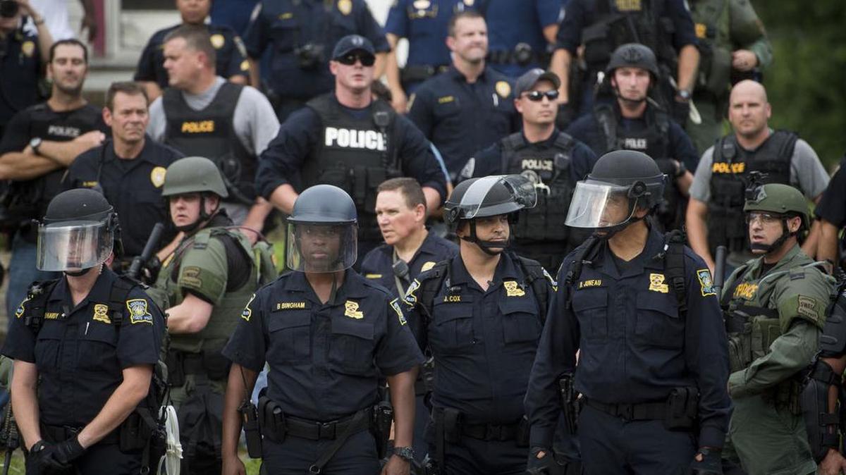 Law enforcement line up across the street from protesters during a protest on East Boulevard in downtown Baton Rouge on Sunday, July 10, 2016.