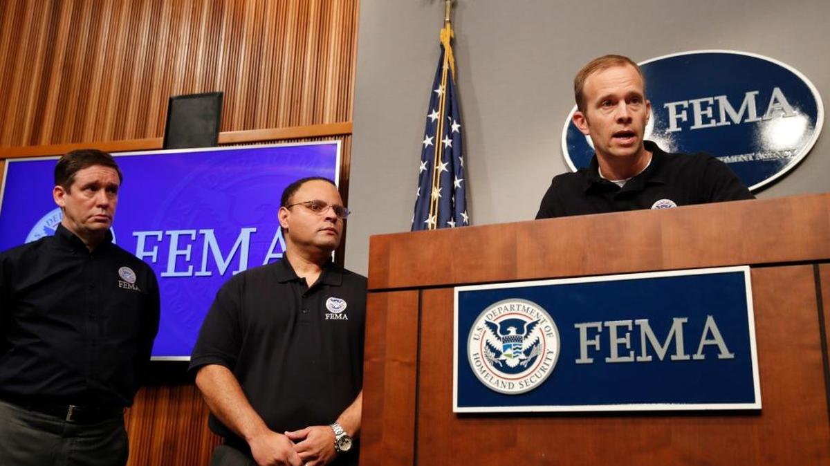 Federal Emergency Management Agency (FEMA) Administrator Brock Long, right, speaks during a news conference in Washington, Thursday, Aug. 31, 2017, about Harvey's devastating flooding. At far left is Deputy Associate Administrator for Insurance and Mitigation Roy Wright, with Alex Amparo, assistant administrator for recovery.