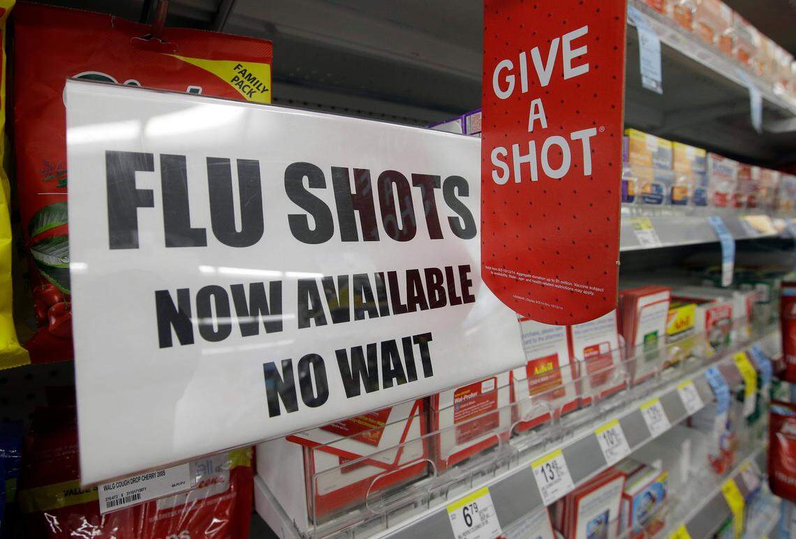 A sign telling customers that they can get a flu shot in a Walgreen store is seen Tuesday, Sept. 16, 2014, in Indianapolis. The nations biggest drugstores and retailers are grabbing larger chunks of the immunization market, giving customers more convenient options to protect themselves against the flu, pneumonia and more than a dozen other illnesses. (AP Photo/Darron Cummings)