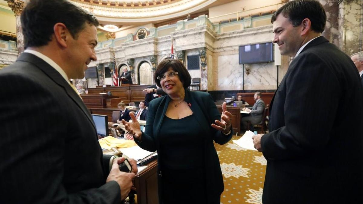 Sen. Barbara Blackmon, D-Canton, center, jokes about being seen conferring with Republican Sens. Chris McDaniel, R-Ellisville, left, and Michael Watson, R-Pascagoula, Wednesday at the Capitol.