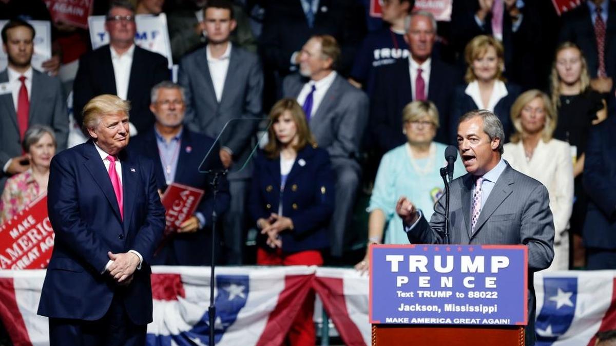 Nigel Farage, ex-leader of the British UKIP party, speaks as Republican presidential candidate Donald Trump, left, listens at Trump's campaign rally in Jackson on Wednesday.