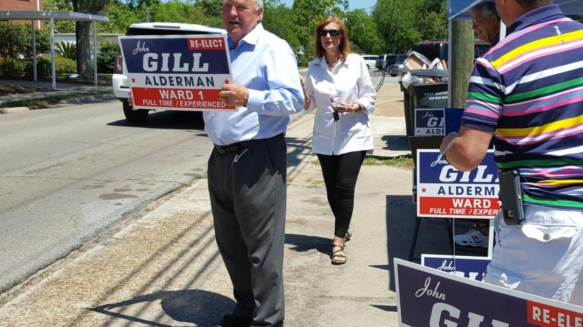 Ocean Springs Ward 1 incumbent Alderman John Gill waves to voters heading to the polls from a safe distance of 150 feet or more from the voting precincts, as required by law.