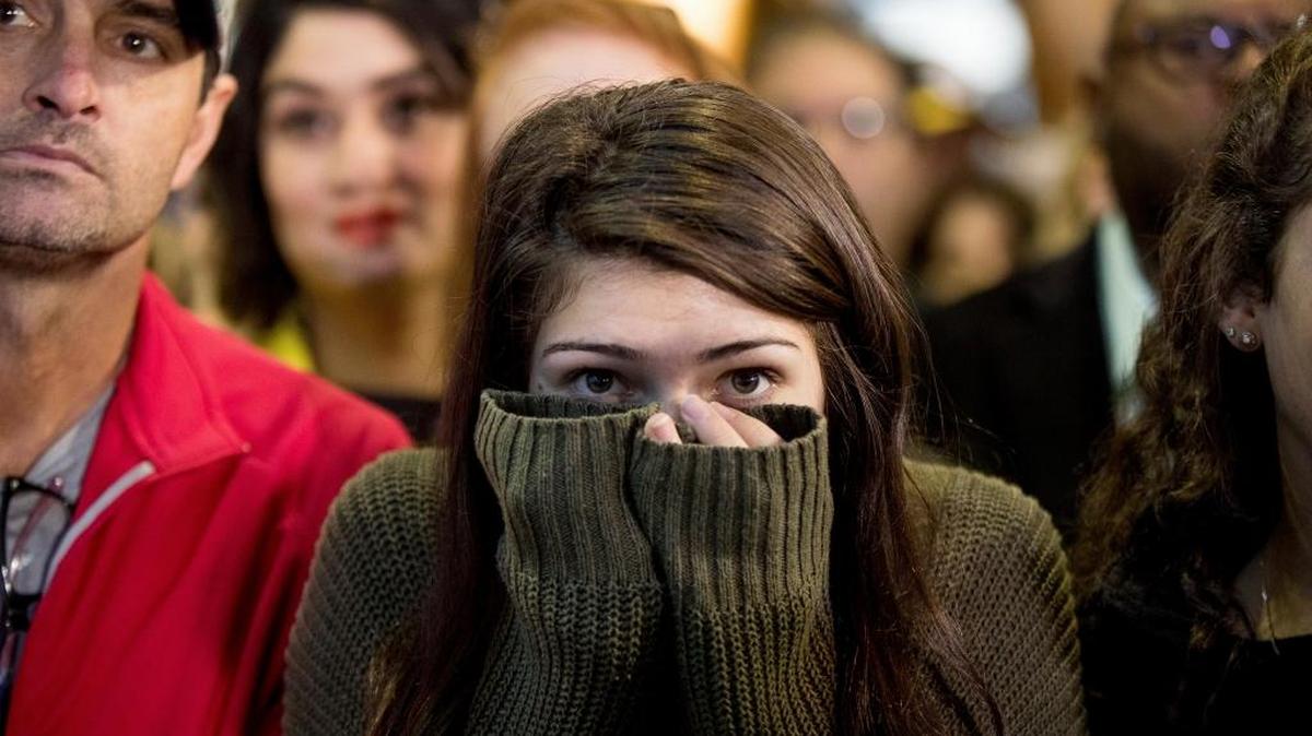 A woman in the audience listens at a rally Friday.