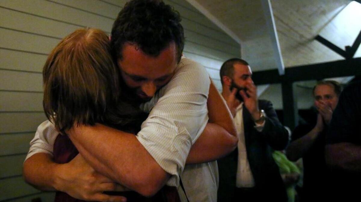 Shea Dobson hugs his mother, Mary Debell after winning the election for the next Ocean Springs mayor on Tuesday.