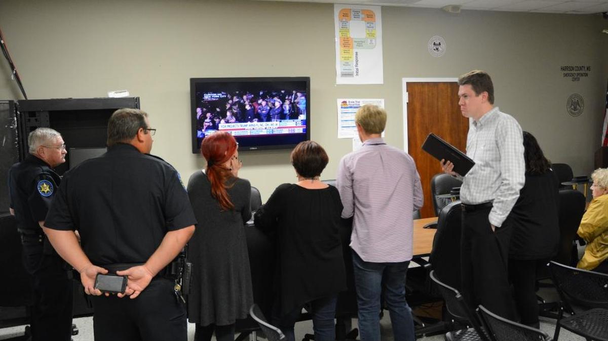 Harrison County officials play close attention to the national presidential race as they wait for ballot boxes to come in from the 58 county precincts Tuesday night.