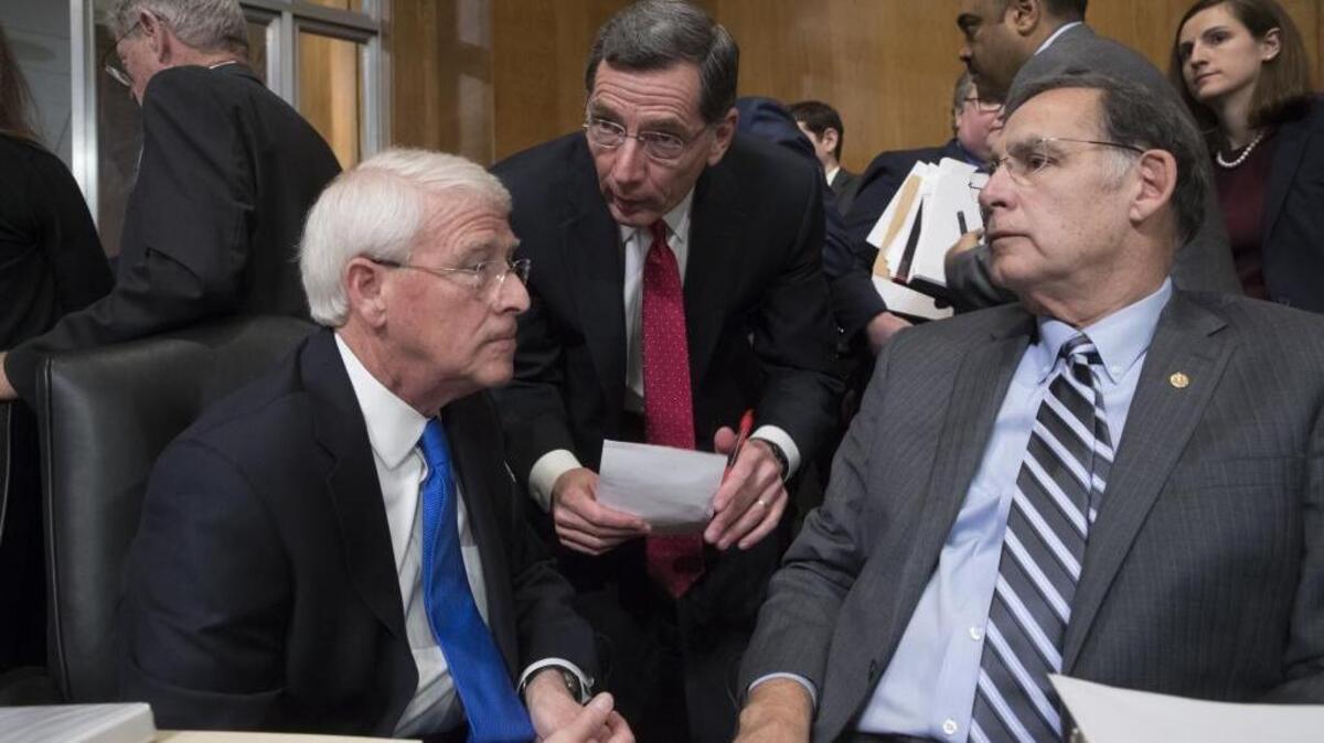 Senate Environment and Public Works Committee Chairman Sen. John Barrasso, R-Wyo., center, flanked by Sen. Roger Wicker, R-Miss., left, and Sen. John Boozman, R-Ark., talks on Capitol Hill during the committee’s confirmation hearing for Environmental Protection Agency Administrator-designate Scott Pruitt.