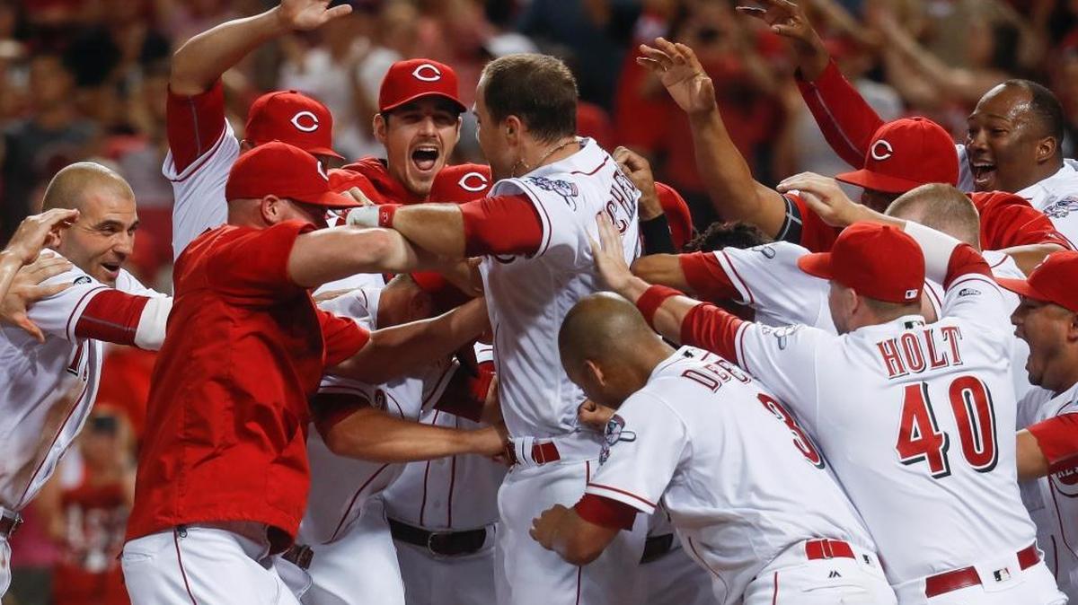 Cincinnati Reds' Scott Schebler, center, celebrates with his teammates after hitting a walk-off, three-run home run off St. Louis Cardinals relief pitcher Seung Hwan Oh during the ninth inning Tuesday.