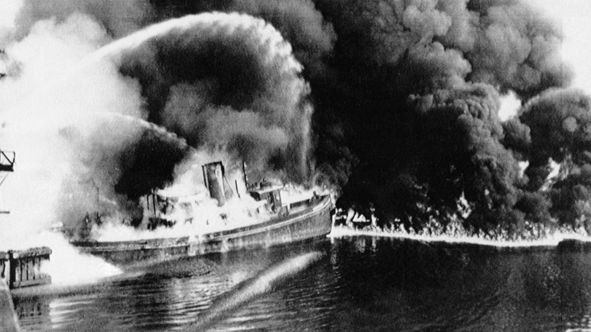 A fire tug fights flames from oil and other industrial waste that caught fire on the Cuyahoga River near downtown Cleveland in 1952. That, scientists suggest, was the beginning of an epoch of havoc created by humans.