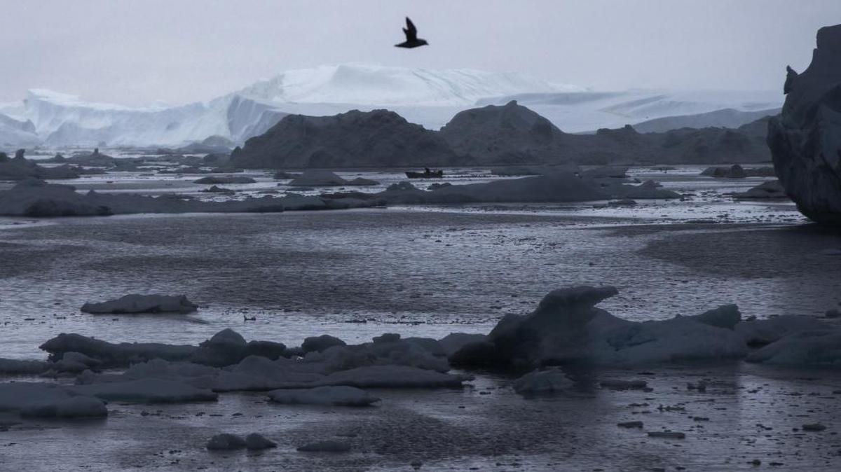 A fisherman drives a boat during Secretary of State John Kerry’s tour of the Jakobshavn Glacier and the Ilulissat Icefjord near the Arctic Circle in Ilulissat, Greenland. A federal report released in December said warming at the top of the world went into overdrive, happening twice as fast as the rest of the globe and extending unnatural heating into fall and winter.