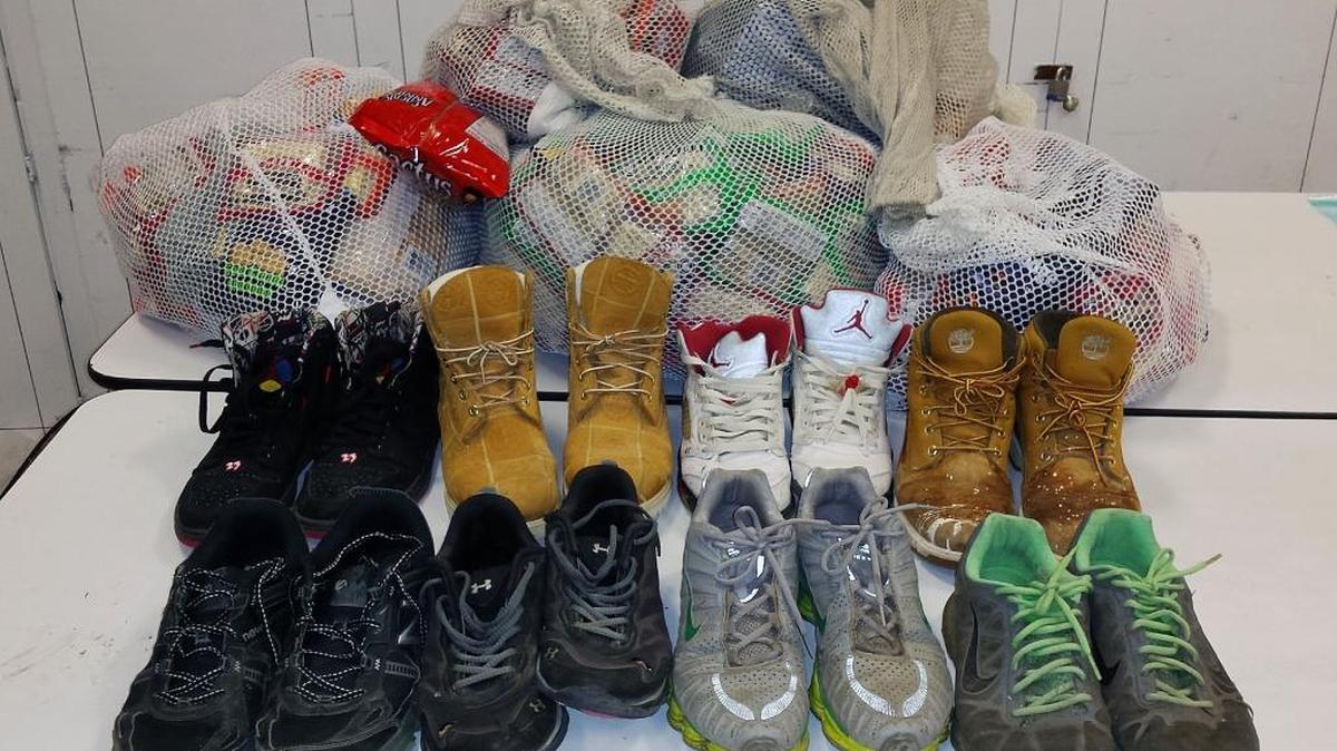 The bags behind the shoes are filled with confiscated Ramen noodles.