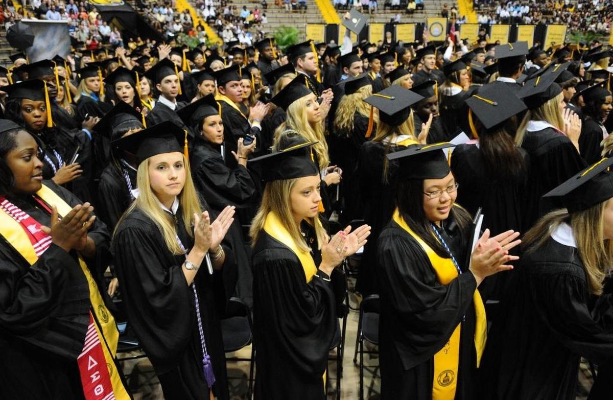 Graduates applaud during Commencement exercises at the University of Southern Mississippi in Hattiesburg.