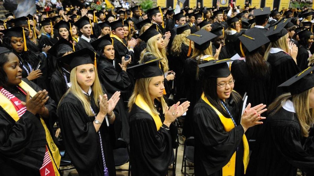 Graduates applaud during Commencement exercises at the University of Southern Mississippi in Hattiesburg.