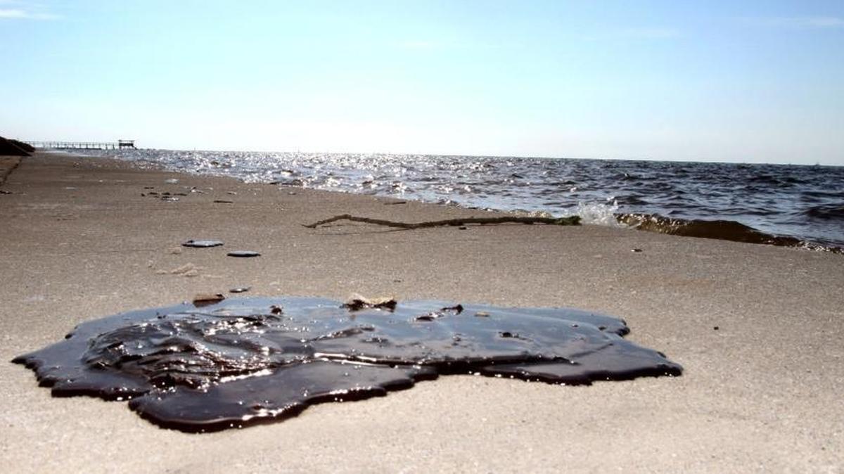 Oil the size of a football sits on the beach in Waveland from the BP oil disaster in 2010. BP will pay the state a total of $750 million for the economic damages and candidates for supervisor say Hancock County needs to get its share of that money for economic development.