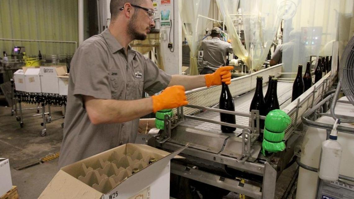 James McColley fills a box with a special run of 10th anniversary beer at Lazy Magnolia brewery in 2015.