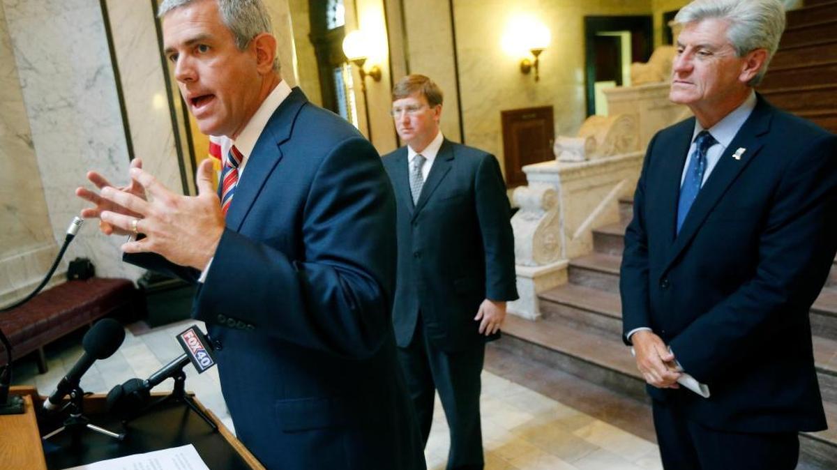 House Speaker Philip Gunn, R-Clinton, left, outlines the shared goals of fellow Republicans Gov. Phil Bryant, right, and Lt. Gov. Tate Reeves for an overhaul of the budget and taxes.