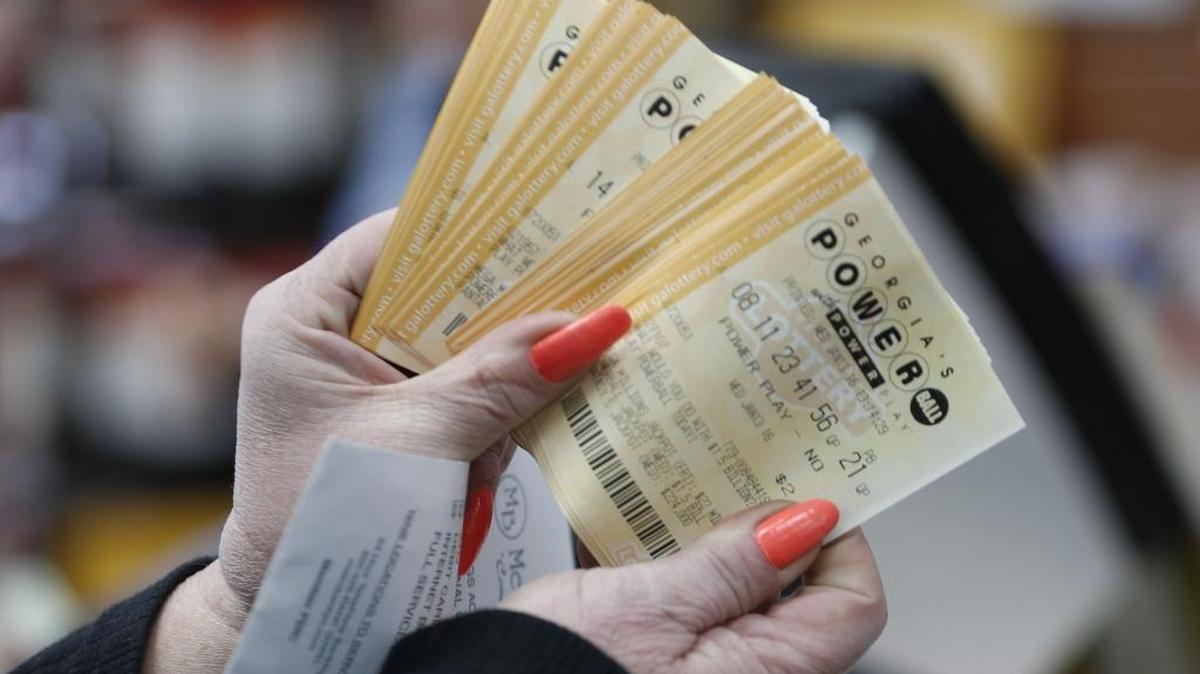 A lottery player displays Powerball lottery tickets at store in Tallapoosa, Georgia, in 2016. The average Georgia resident outspends most Americans on lottery tickets.