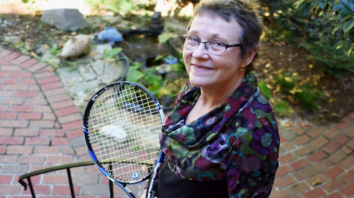 In this photo taken Oct. 19, 2015, breast cancer survivor Ann Harsh, inspired by her tennis team as they supported Harsh through chemotherapy treatments, poses in Hattiesburg, Miss. Harsh was diagnosed a year ago and finished her last treatment of October 2015