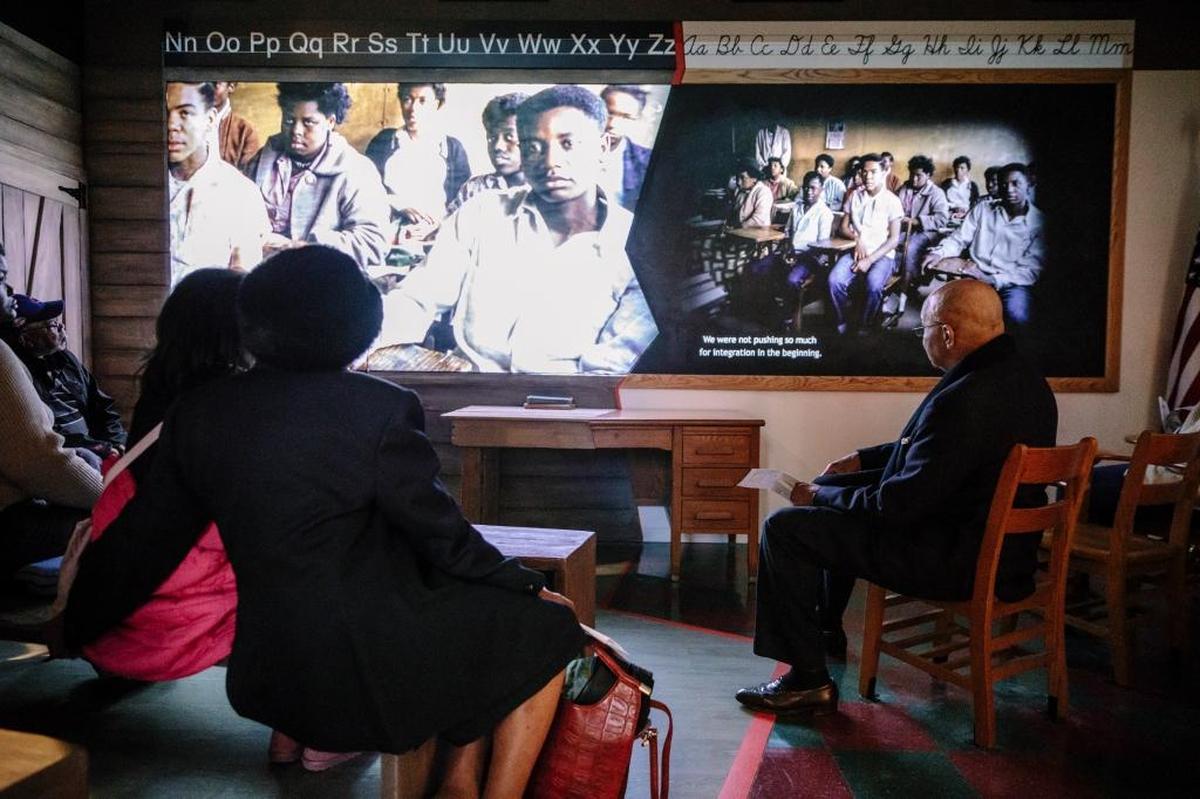 Visitors in a segregated classroom installation that explains how the Brown v. Board of Education decision helped ignite the Civil Rights Movement, at the Mississippi Civil Rights Museum in Jackson, Dec. 10, 2017. The museum, with its concentrated time frame — roughly 30 years between World War II and the mid-1970s — refuses to sugarcoat history.