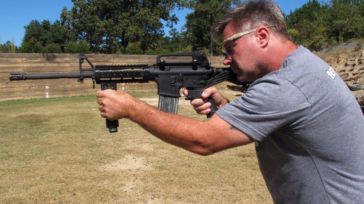 Shooting instructor Frankie McRae aims an AR-15 rifle fitted with a "bump stock" at his 37 PSR Gun Club in Bunnlevel, N.C., on Wednesday, Oct. 4, 2017. The stock uses the recoil of the semiautomatic rifle to let the finger "bump" the trigger, making it different from a fully automatic machine gun, which are illegal for most civilians to own.