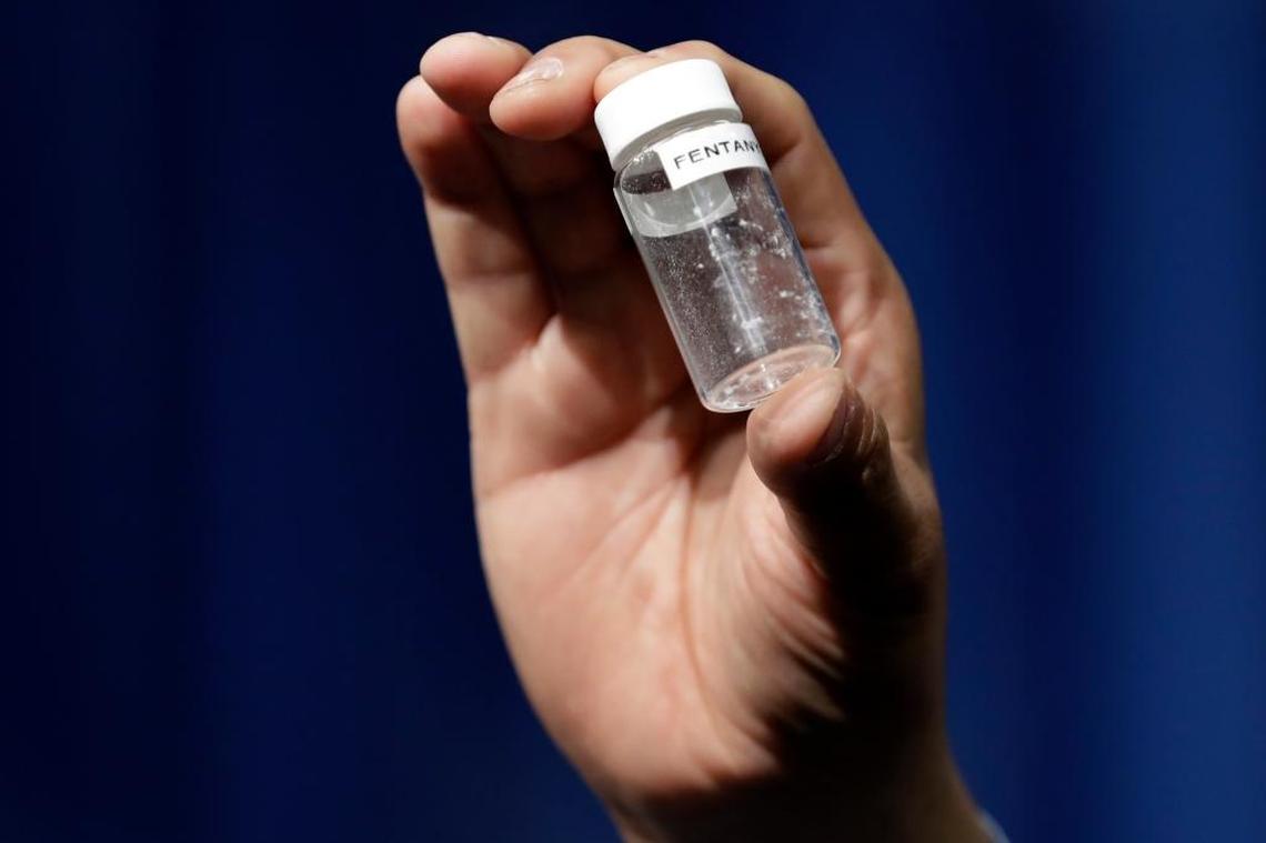 A reporter holds up an example of the amount of fentanyl that can be deadly after a news conference June 6 about deaths from fentanyl exposure, at DEA Headquarters in Arlington, Virginia.