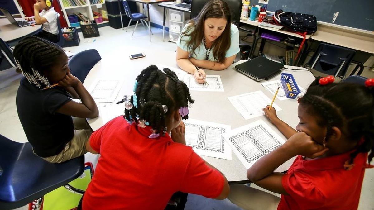 Arlington Elementary School third grade teacher Kathy Shoemaker goes over a reading worksheet with her students on April 25 in Pascagoula.