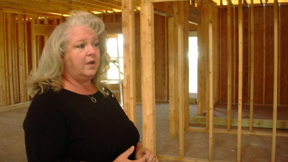 In November 2009, Carla Sue ‘Susie’ Prescott stands inside the unfinished home in Waveland that an unlicensed builder never finished. Prescott had already spent all of her Hurricane Katrina recovery money on the job.