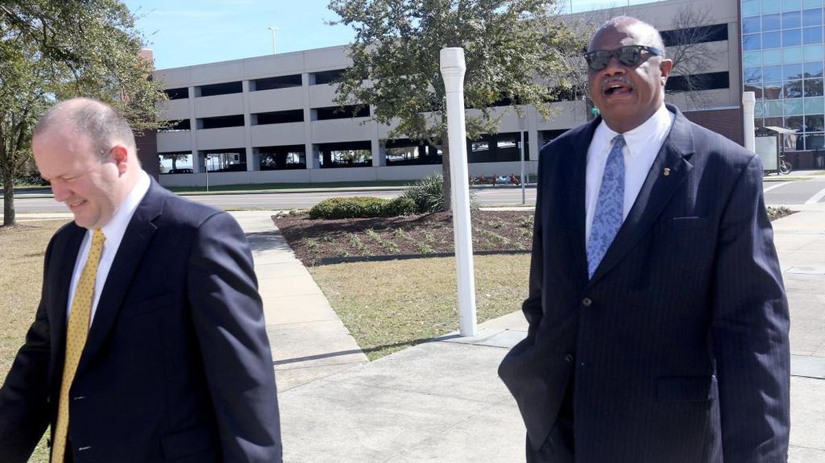 Business consultant Robert Simmons, right, and his attorney, K.C. Hightower, walk to the Dan M. Russell, Jr., federal courthouse in Gulfport on Thursday Feb. 18, 2015, for his initial appearance on a federal bribery charge in the public corruption case that involves former state corrections Commissioner Chris Epps.
