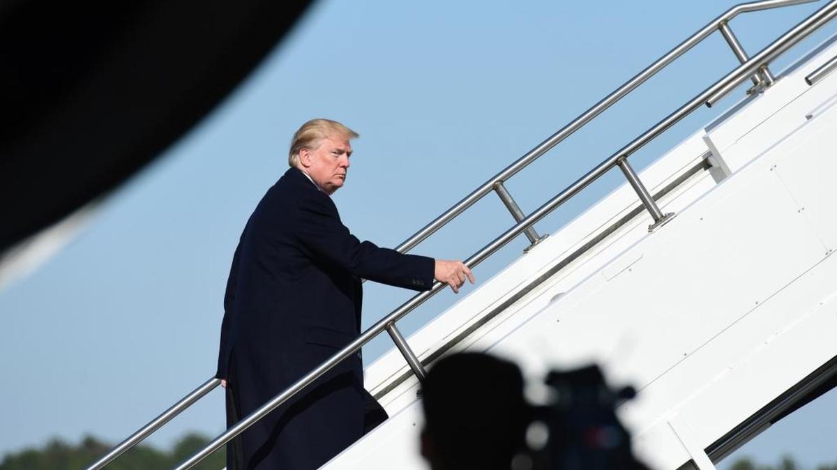 President Donald Trump walks up the steps of Air Force One at Jackson-Medgar Wiley Evers International Airport in Jackson, Miss., Saturday, Dec. 9, 2017. Trump spoke at the opening of the Mississippi Civil Rights Museum in Jackson.