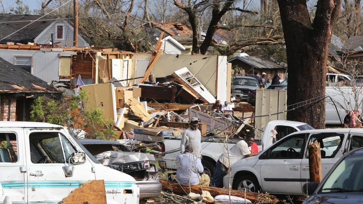 Residents of Magnolia Street in Hattiesburg take a break from cleaning up after a tornado Saturday.