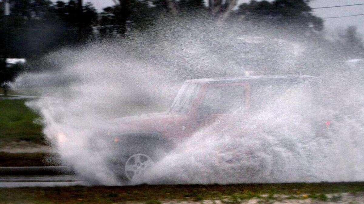 A motorist blasts through a puddle of water on U. S. 90 in Gulfport, Friday, Jan. 6, 2017. Cold temperatures could drop below freezing causing puddles to freeze. Motorists should be on the lookout for icy roads and bridges Saturday.