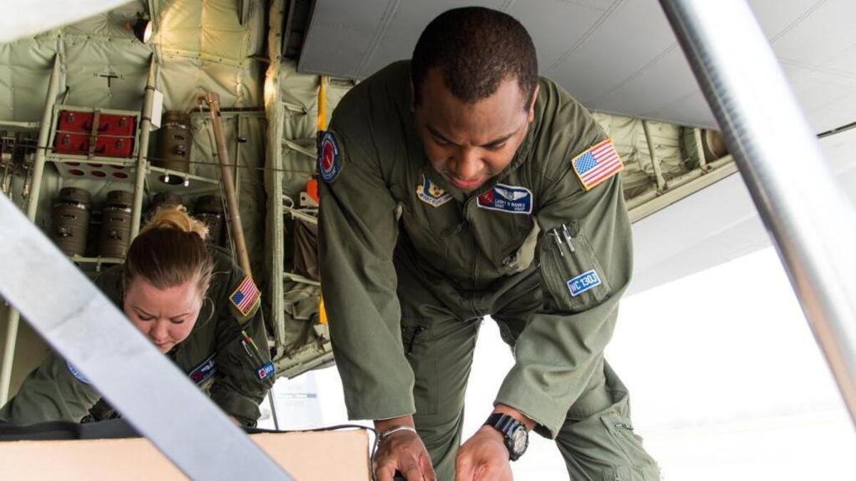 Staff Sgt. Larry Banks, right, and Tech. Sgt. Jenna Daniel, 53rd Weather Reconnaissance Squadron loadmasters, read instructions for U.S. Navy weather buoys April 12 at Keesler Air Force Base in Biloxi. These buoys were dropped in preparation for the Naval Oceanography unmanned systems Gulf of Mexico Operational Demonstration May 30 through June 1 in Gulfport. This joint training opportunity allows the 53rd WRS and Navy personnel to practice collecting and analyzing atmospheric and oceanic data. The Hurricane Hunters also are on a Caribbean Tour this week ahead of the 2017 hurricane season.