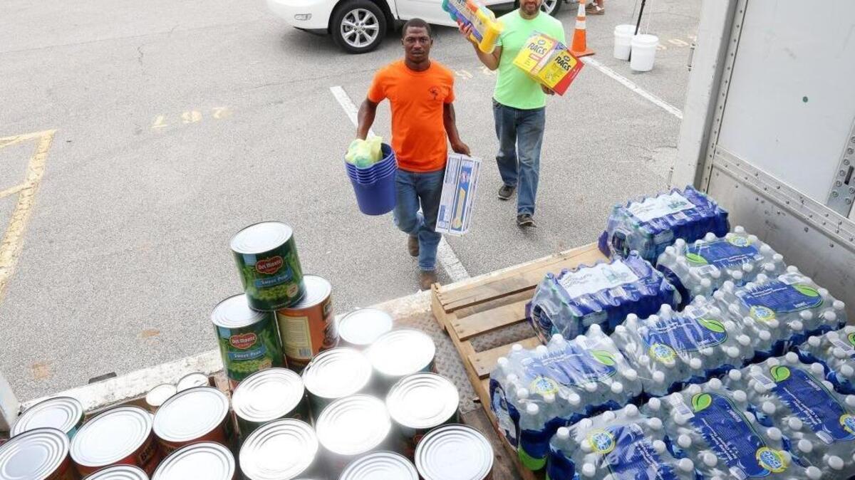 Mario Shade of Wiggins, left, and Clint Ireland of Perkinston carry donated hurricane relief supplies for Hurricane Harvey victims to a waiting truck in the Island View Casino Resort parking lot in Gulfport on Monday, Aug. 28, 2017.