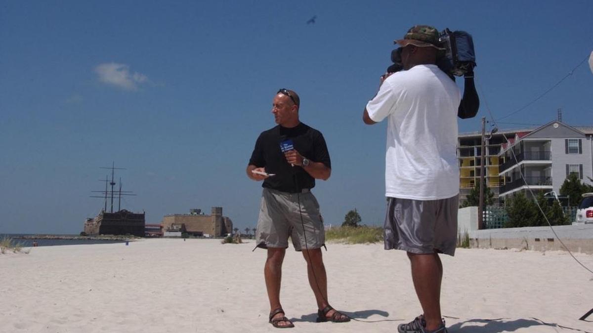 Weather Channel correspondent Jim Cantore does a live television broadcast from the beach in Biloxi August 27, 2005, two days before Hurricane Katrina struck the Gulf Coast.