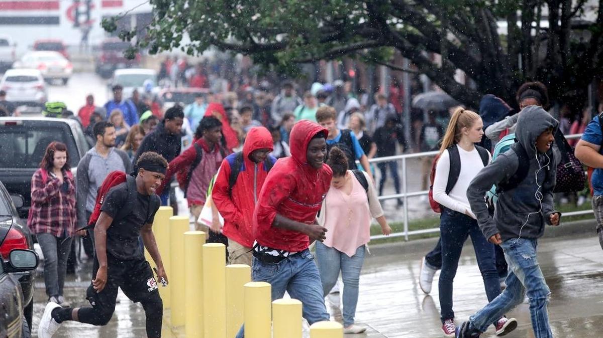 Harrison Central High School students head for the buses after being dismissed early because of rain Thursday.