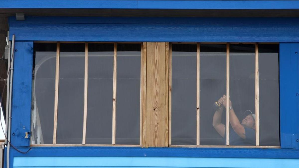 James Dubois of Biloxi puts reinforcements behind Plexiglas windows on the third floor of The Reef restaurant in biloxi on Saturday in preparation for Hurricane Nate