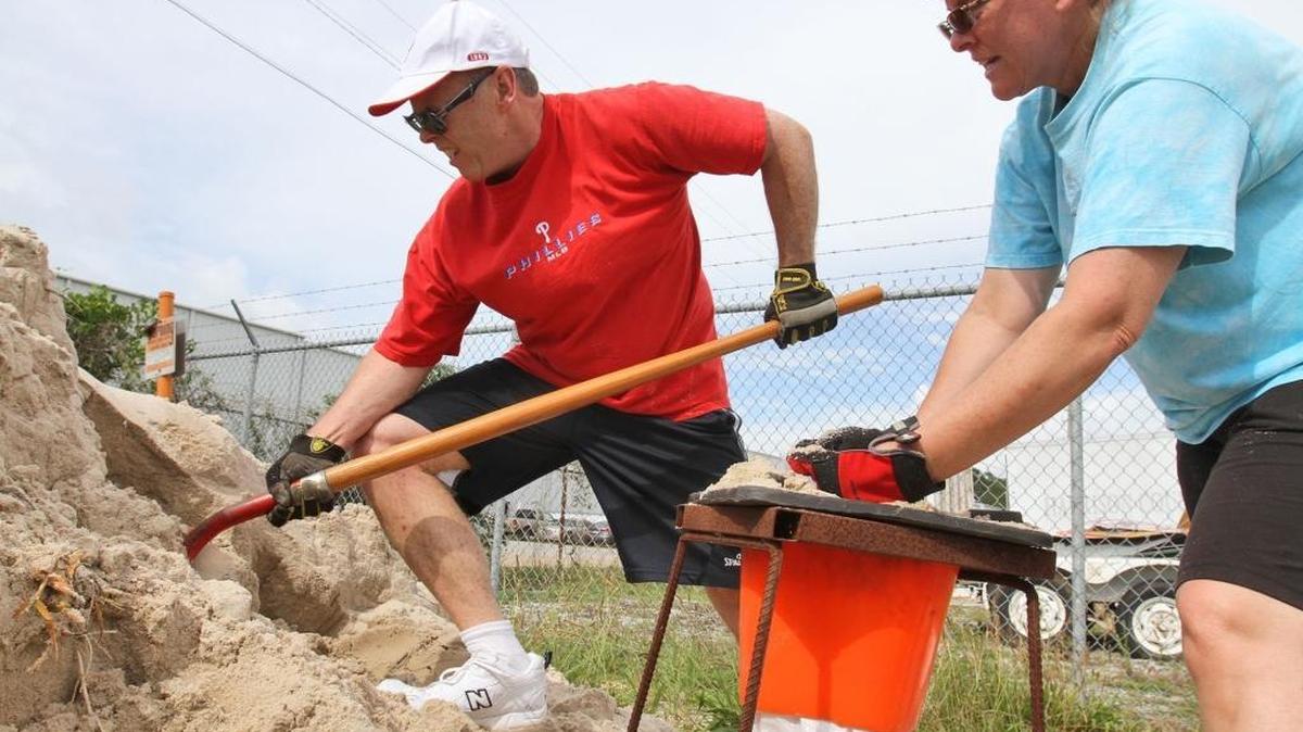 Bill and Leslie O'Brien of Vancleave fill sandbags on Monday, June 19, 2017 at the Harrison County Road Department in Gulfport for a disabled friend in preparation for expected heavy rains later this week from a tropical system developing in the Gulf of Mexico.