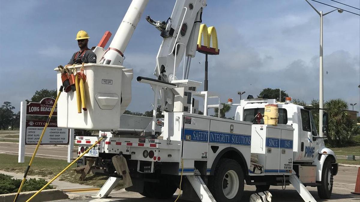 A Pike power company lineman prepares to work at restoring power to the Long Beach Harbor on Sunday after Hurricane Nate.