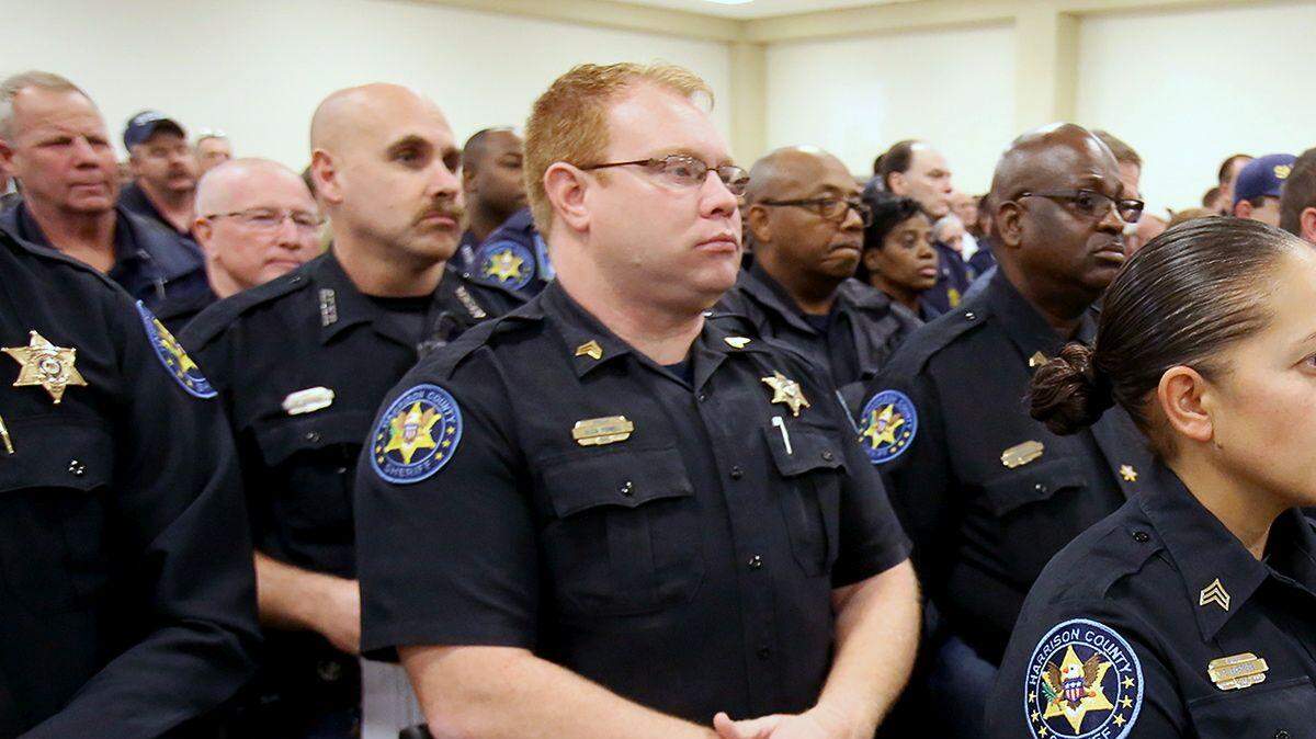 Harrison County Sheriff's Office deputies stand ready to be sworn in by Sheriff Troy Peterson on Jan. 3. Peterson told them he plans to make them the highest-paid deputies in the state. They are among the lowest-paid law enforcement officers in Harrison County.