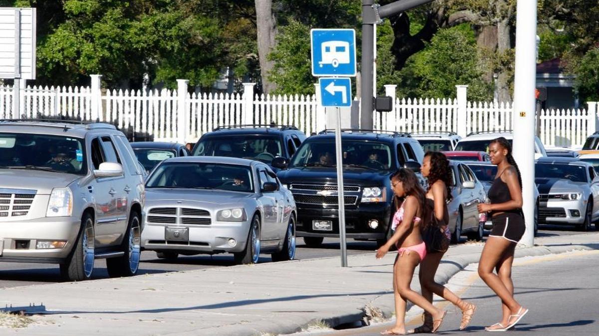 Spring breakers cross U. S. 90 during a break in traffic near Beauvoir in April 2016 during Spring Break weekend.
