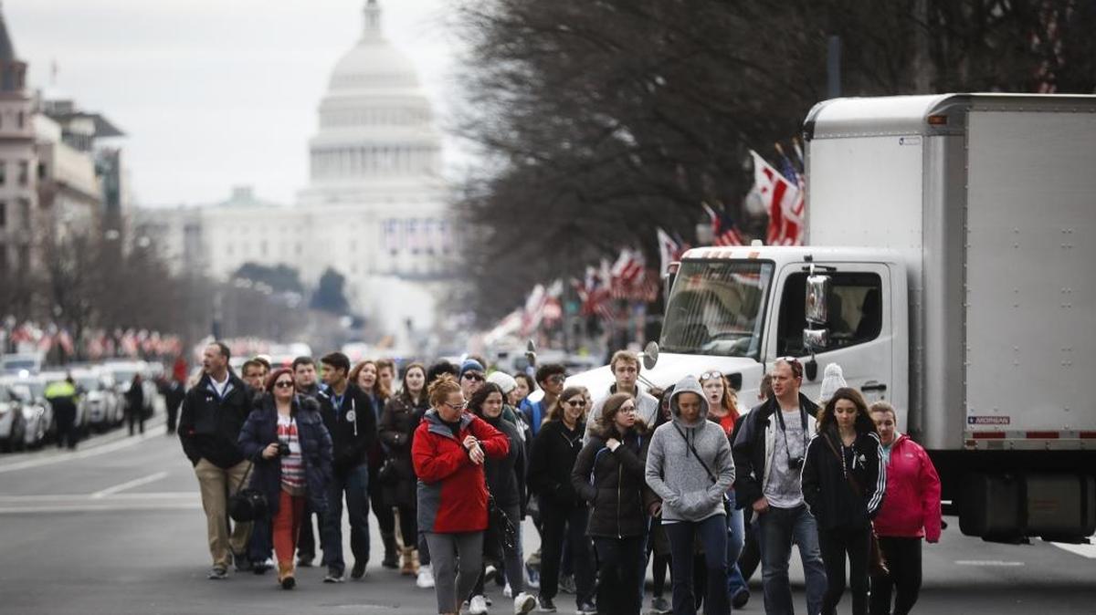 With the Capitol in the background, people walk along Pennsylvania Avenue in Washington on Thursday as preparations continue for Friday's presidential inauguration.