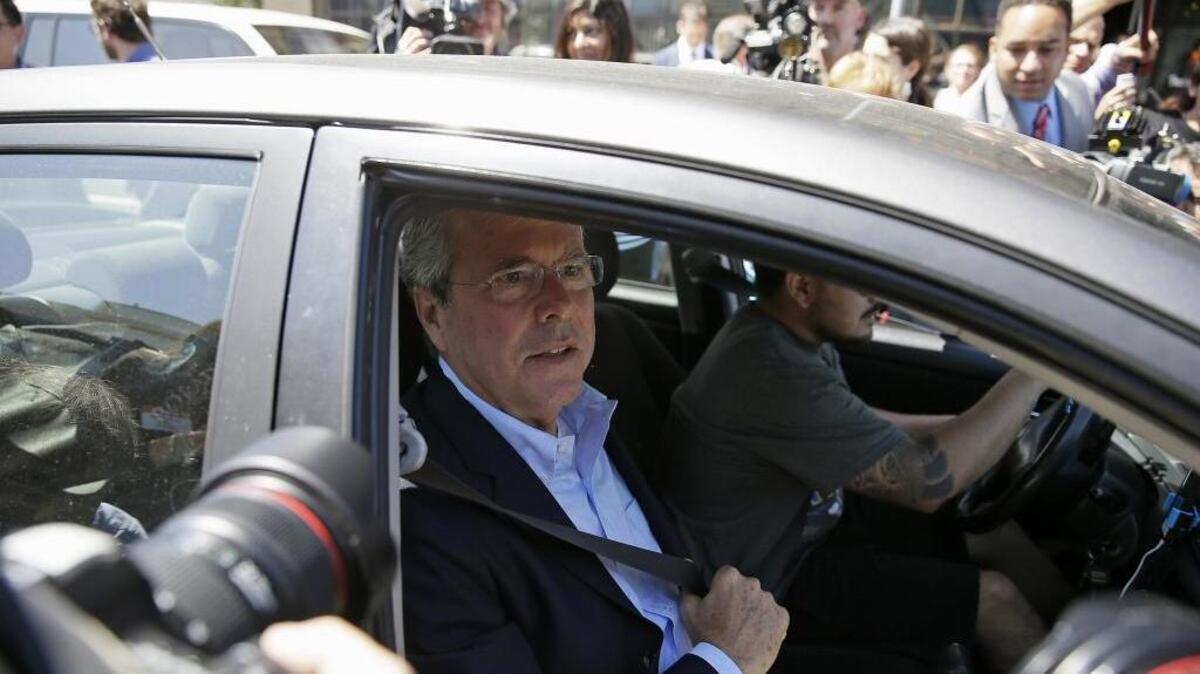 Former Florida Gov. Jeb Bush puts on his seat belt in an Uber car after speaking at Thumbtack, an online startup in San Francisco. See? It’s so easy a politician can do it.