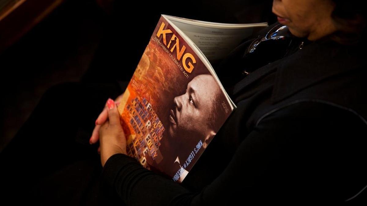 Doris Gray sits with a program during the Rev. Martin Luther King Jr. holiday commemorative service at Ebenezer Baptist Church where King preached, Monday, Jan. 18, 2016, in Atlanta.