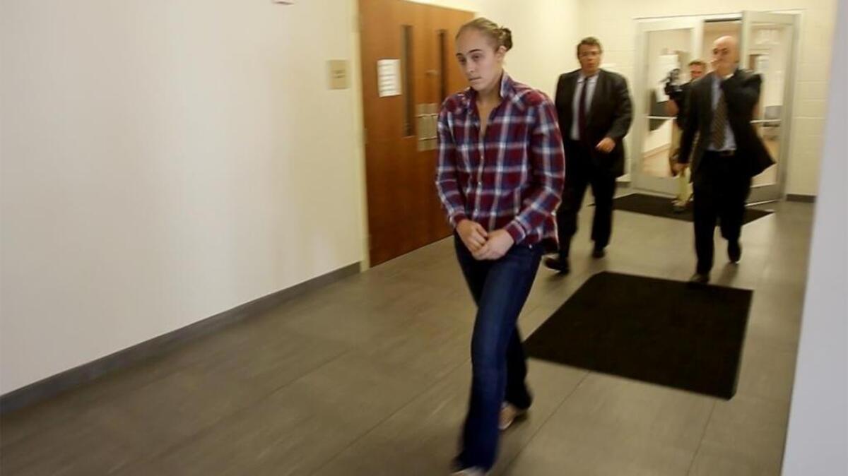 Former Long Beach police officer Cassie Barker walks out of the Hancock County Public Safety Complex after posting bond on Thursday. A warrant had been issued for her arrest on a charge of manslaughter.