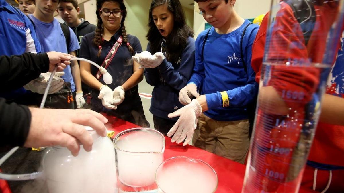 Students crowd around a Mississippi Power booth to see an experiment with dry ice at the Pathways2Possibilities career expo in November 2015. The two day event offers 8th graders from the six lower counties in Mississippi a chance to explore various potential career paths ranging from finance and human services to aerospace and marine science.