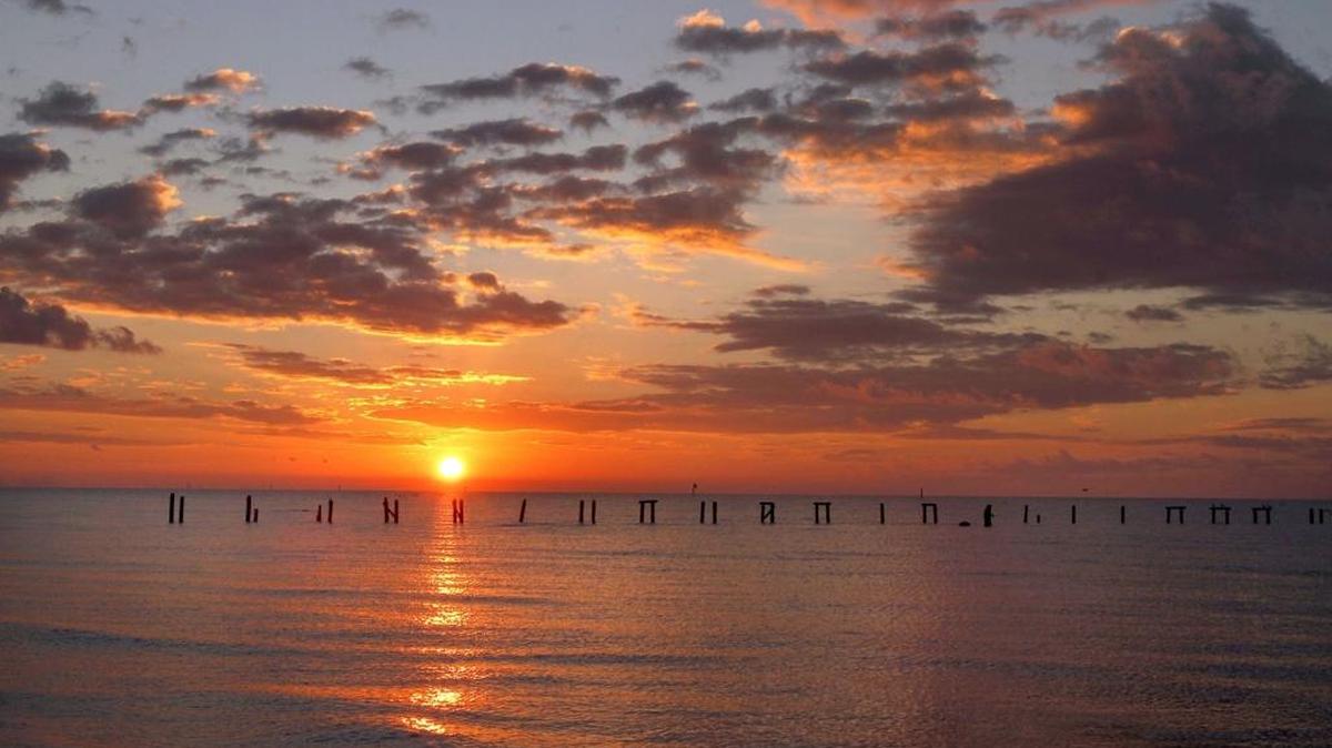 The sun rises over the Mississippi Sound.