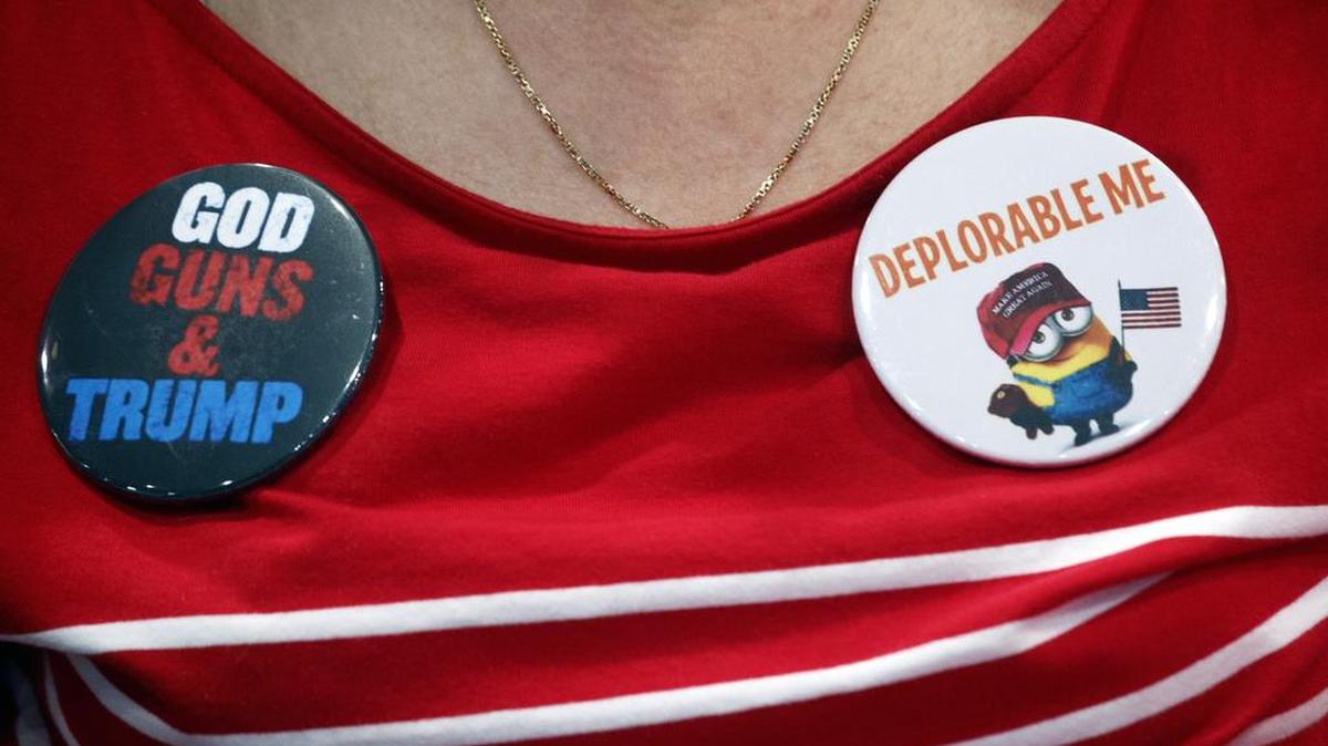 A supporter of President Donald Trump wears buttons on her shirt as Trump appears at a rally on Thursday night in Las Vegas.