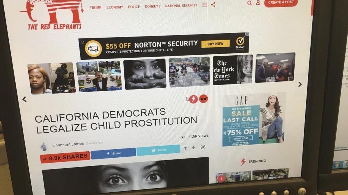 A fake news story is positioned near ads from major global corporations on The Red Elephants website.